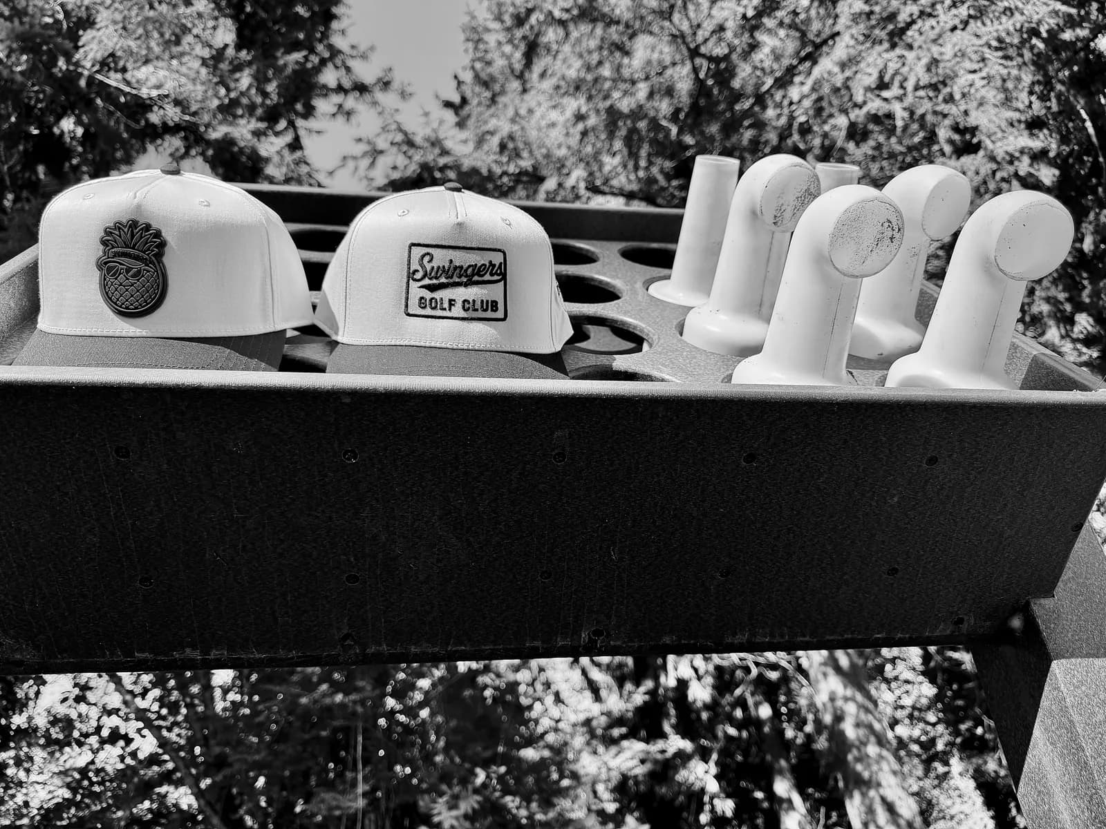 Lifestyle shot — Swingers Club gear at the driving range